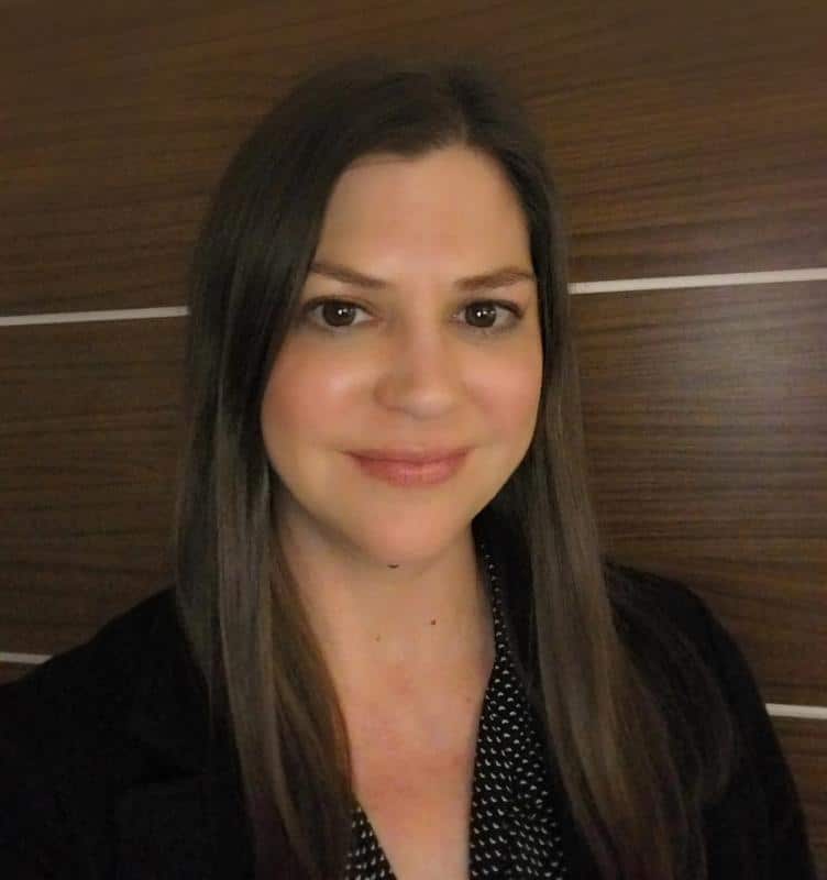 Lauren estness headshot (1) Lauren estness smiling against brown wall background